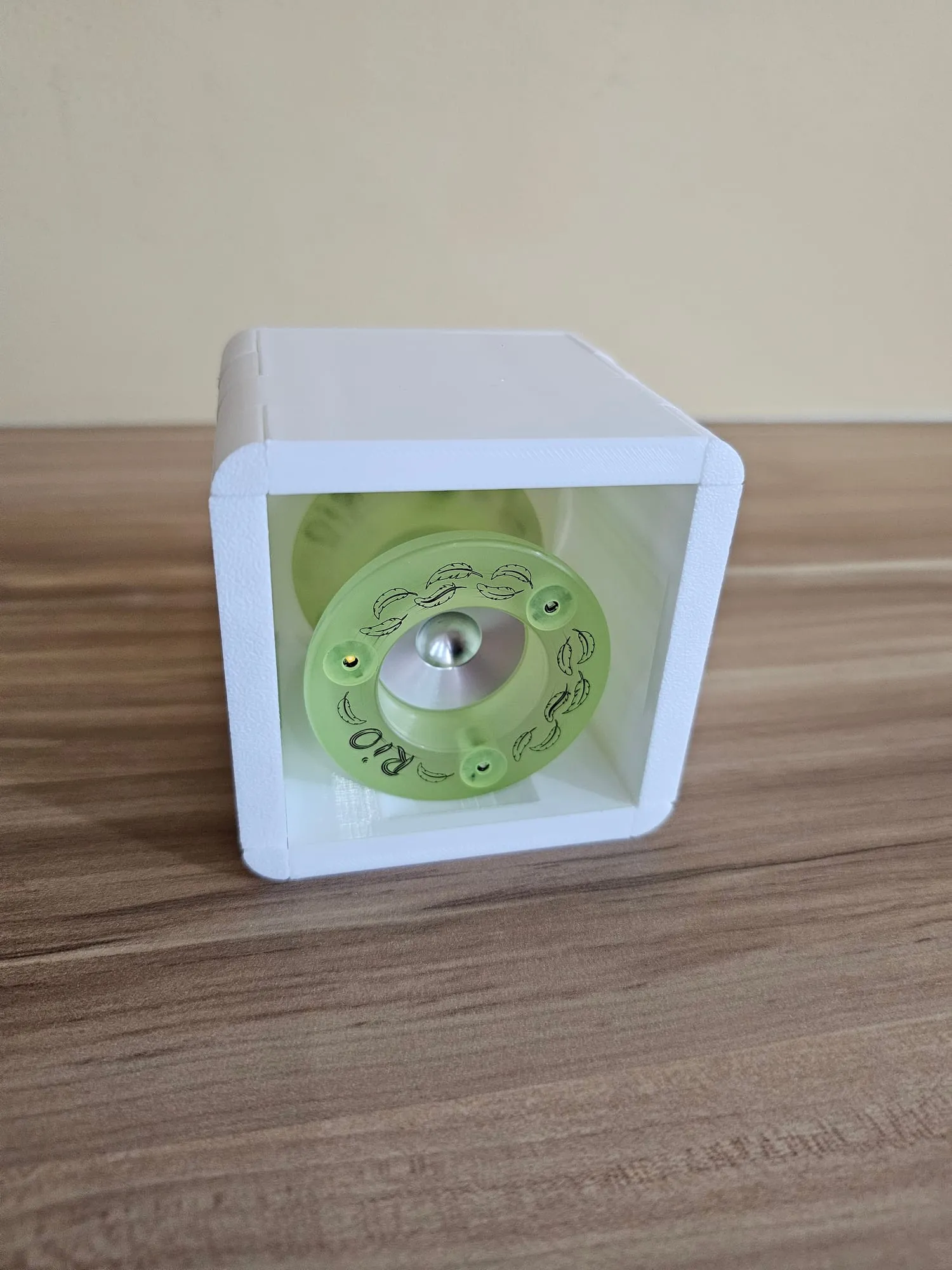 A single white ThrowGRID cube mounted on a wall holding a translucent green yo-yo