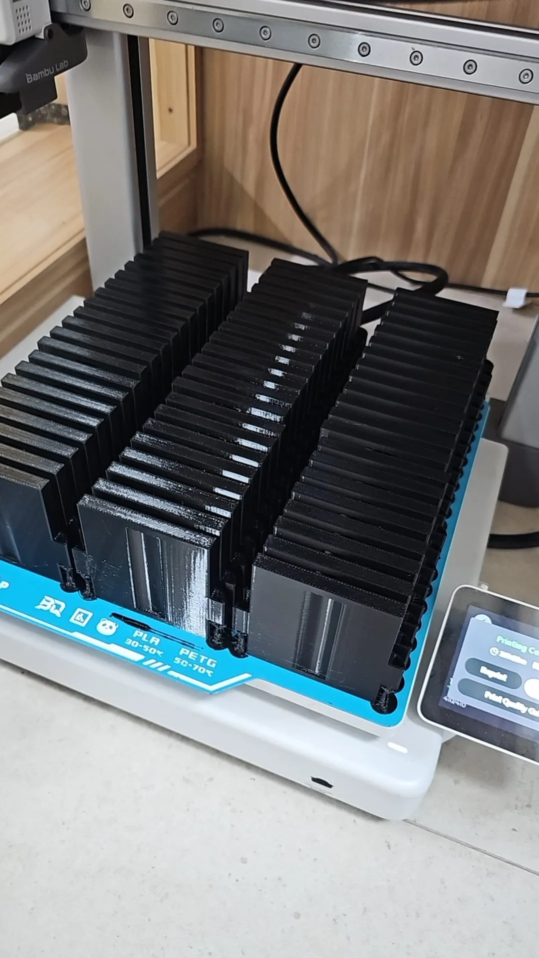 Clear panel prototypes stacked on a print bed